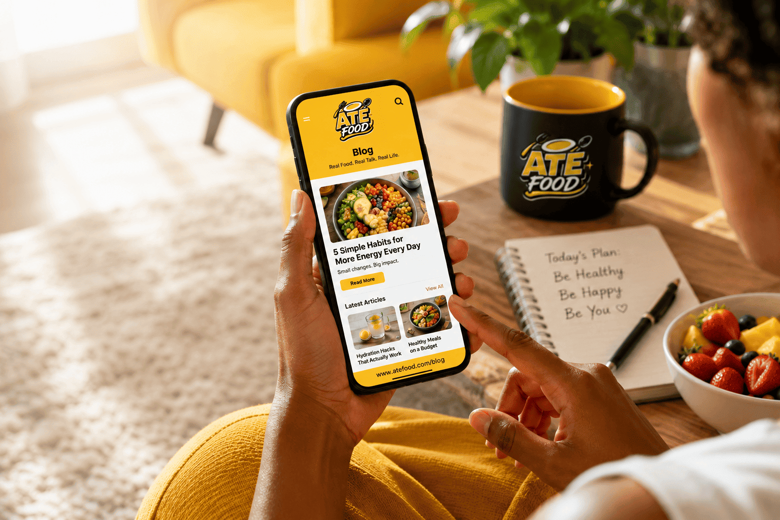 ATE Food blog displayed on a phone beside healthy food and lifestyle notes